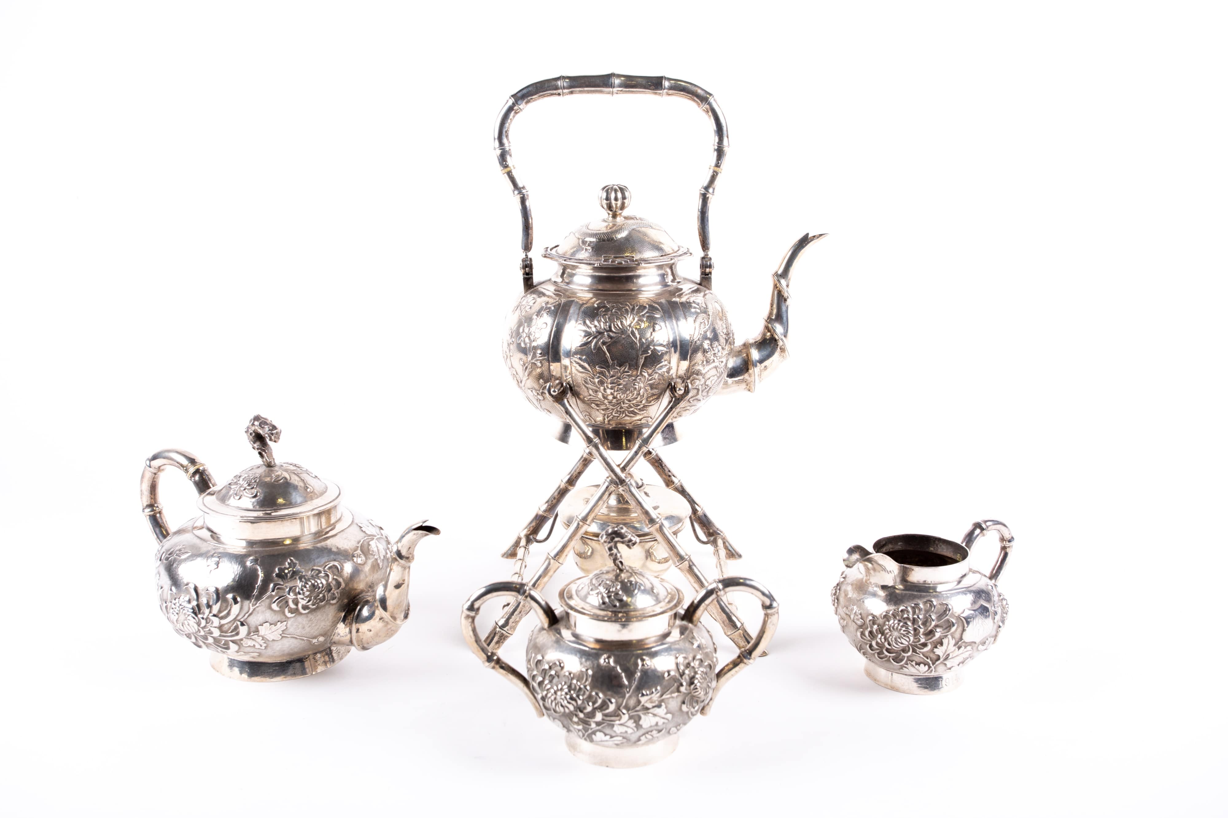 A Chinese four piece silver tea set by Yok Sang