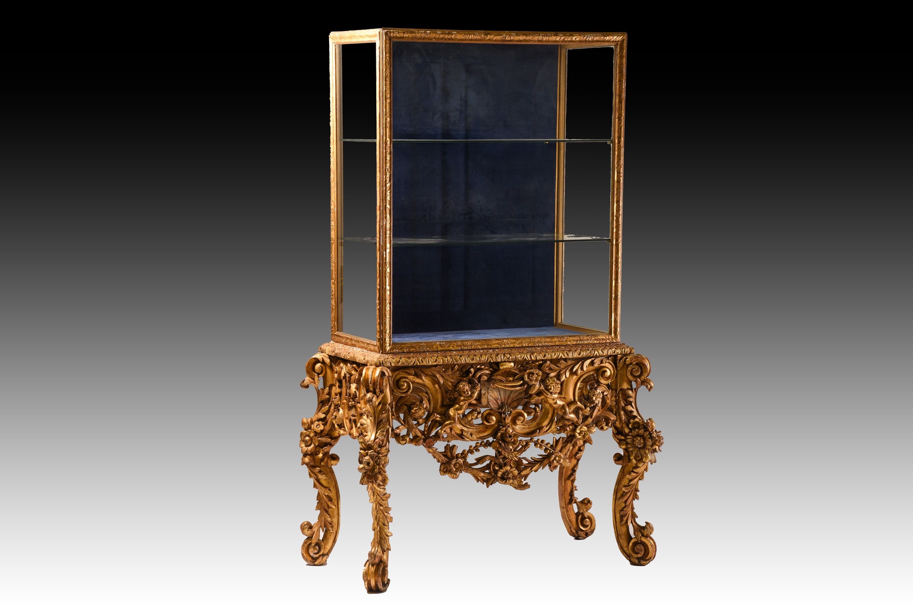 A 17th-century Italian style carved wood and gilt gesso vitrine