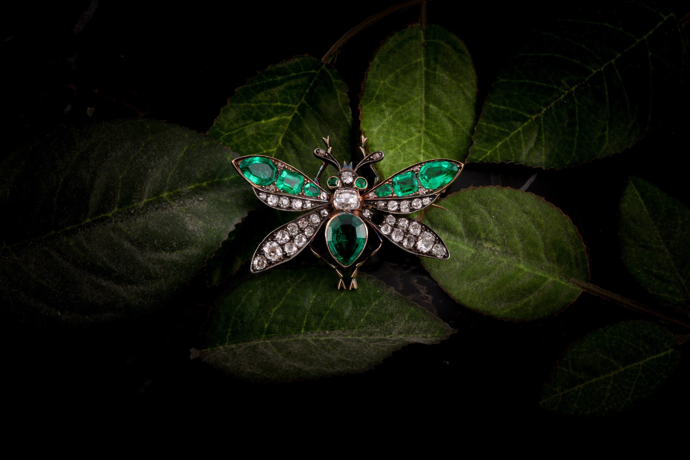 A Victorian diamond and emerald insect brooch in the form of a fly