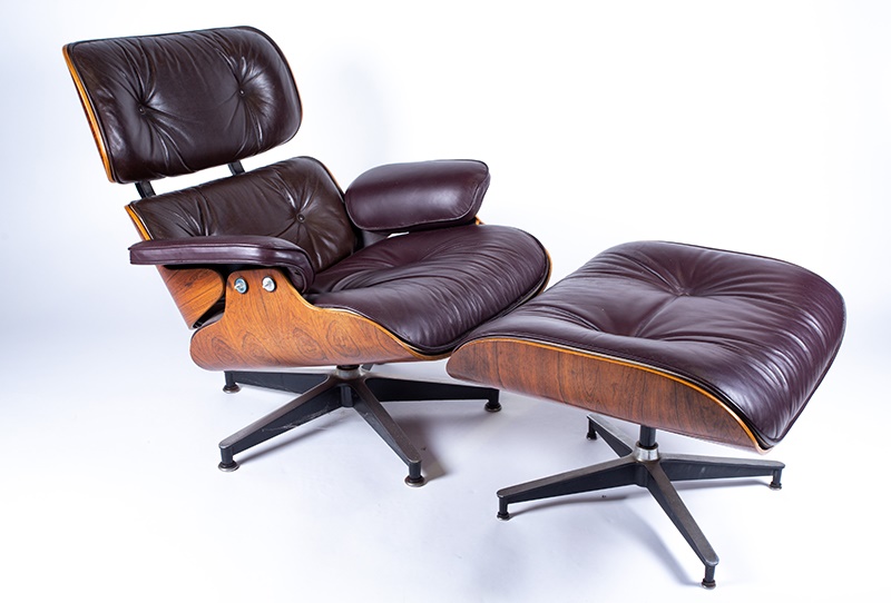 Charles & Ray Eames for Herman Miller - a laminated plywood and rosewood veneered lounger upholstered in buttoned leather and matching ottoman Model No 670 and 671