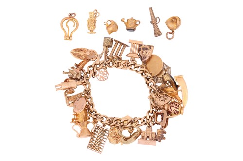 A gold charm bracelet, flat-curb link chain