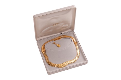 A token necklace together with a single matching earring