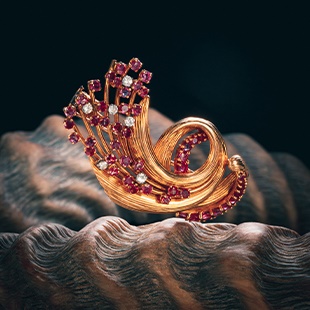 A Kutchinsky diamond and ruby gold brooch