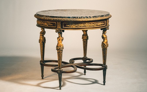 A fine Louis XVI style marble top mahogany gueridon table