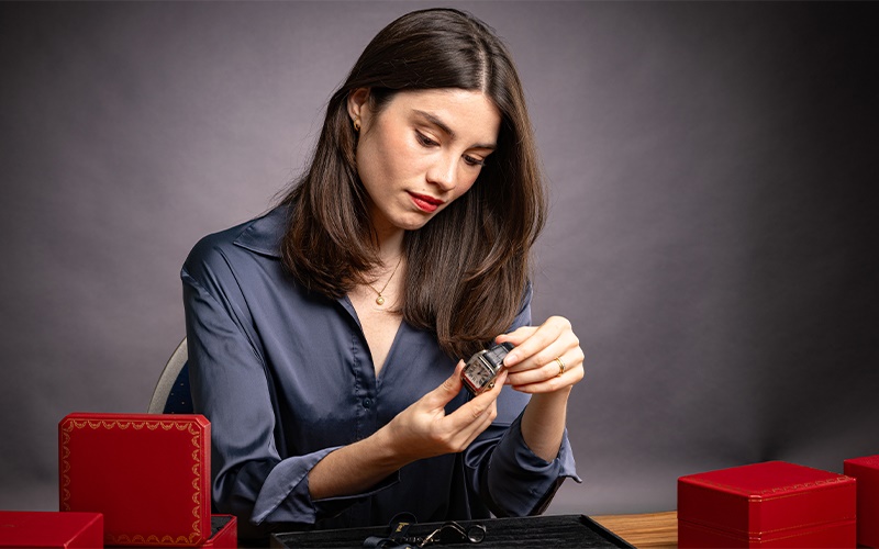 Niamh Thomas appraising Cartier Santos watch