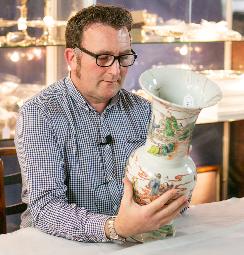 Richard Harrison inspecting a Chinese vase