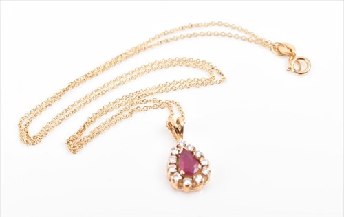 Lot 722 - An 18ct yellow gold, diamond, and ruby pendant...