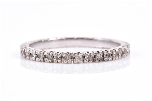 Lot 626 - A diamond full eternity ring set with diamond...