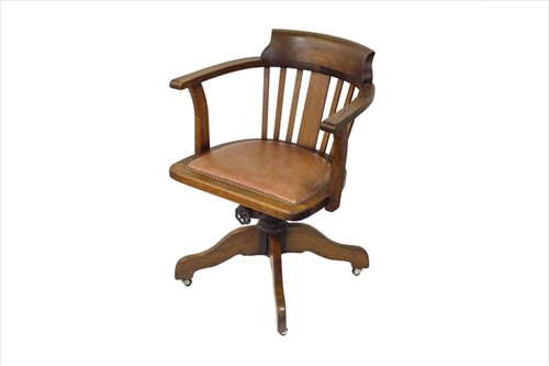 Lot 55 - An early 20th century oak captain's chair with...