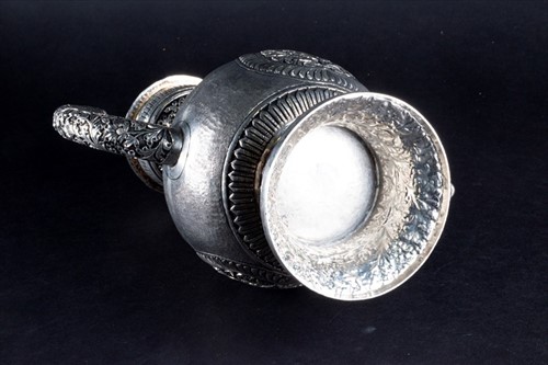 Lot 159 - An Indian white metal jug with hinged lid,...