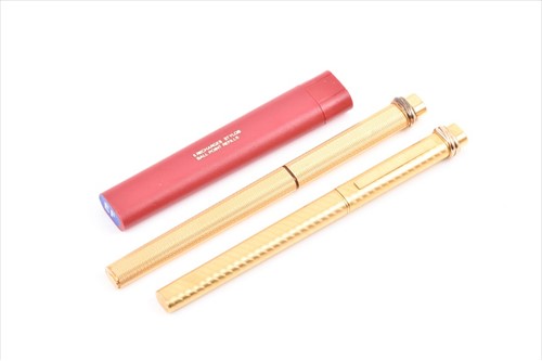 Lot 226 - Cartier. Two similar gold plated pens both...