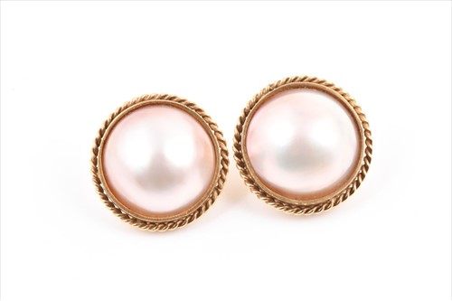Lot 653 - A pair of yellow metal and mabe pearl earrings...