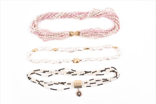 Lot 652 - A quadruple strand pearl necklace set with...