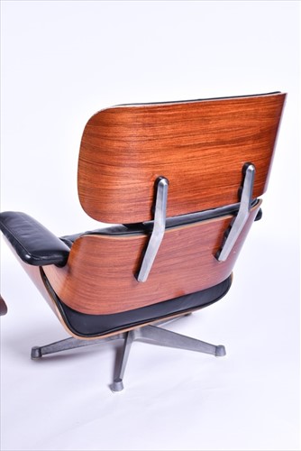 Lot 33 - An Eames-style lounge chair and matching...