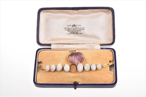 Lot 521 - An early 20th century yellow metal and opal...