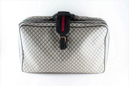 Lot 180 - Gucci. A vintage suitcaseÂ  made of woven...