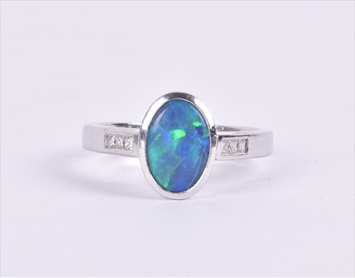 Lot 656 - An 18ct white gold, diamond, and opal ring set...