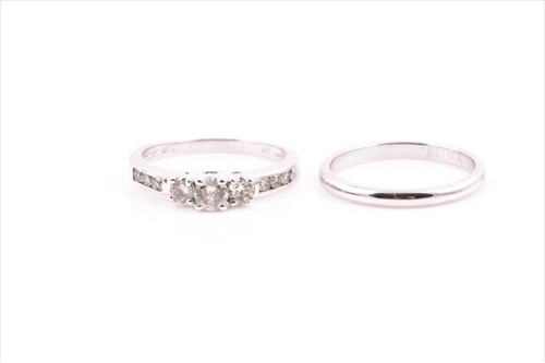 Lot 530 - A diamond engagement ring set with three...