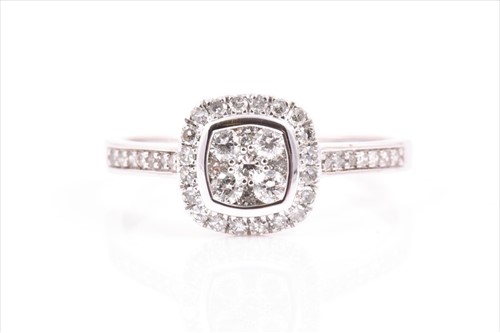 Lot 506 - A 9ct white gold and diamond cluster ring set...