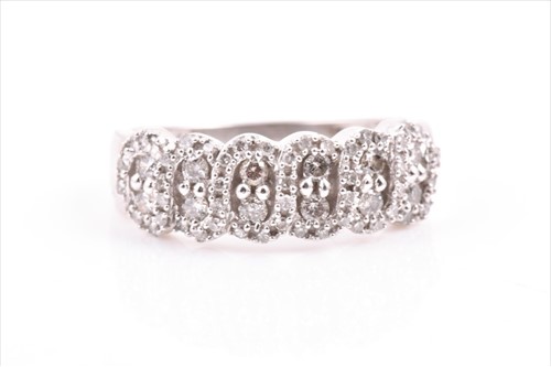 Lot 511 - A white gold and diamond ring the swirled...