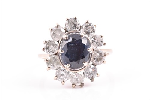 Lot 610A - A white metal, diamond, and sapphire cluster...