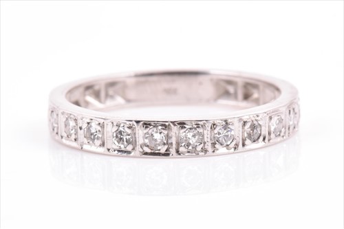 Lot 513 - An 18ct white gold and diamond half eternity...