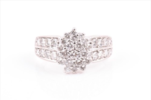 Lot 510 - A 9ct white gold and diamond cluster ring set...