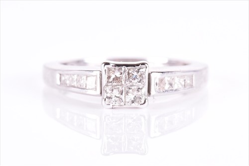 Lot 654 - A white metal and diamond cluster ring set...
