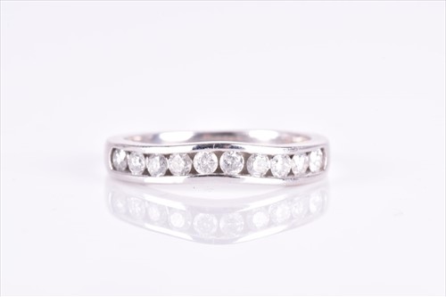 Lot 610 - A 14ct white gold and diamond band ring of...