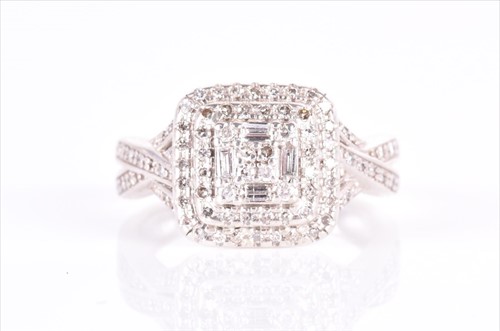 Lot 618 - A silver and diamond cocktail ring set with a...