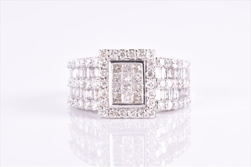 Lot 647 - A silver and diamond cocktail ring set with a...
