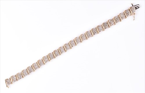 Lot 495A - A yellow metal and diamond line bracelet set...