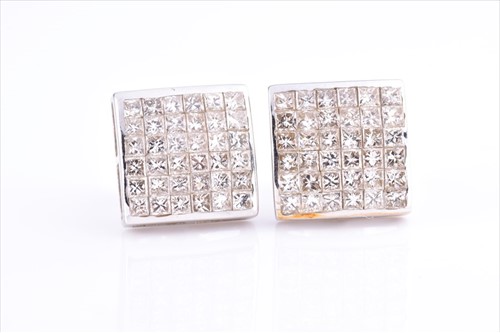 Lot 461 - A pair of 9ct white gold and diamond earrings...