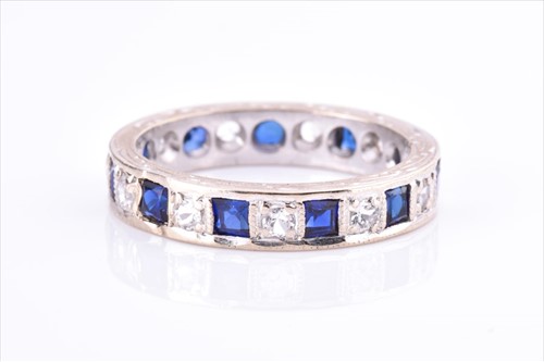 Lot 400 - A blue and white stone eternity ring set with...