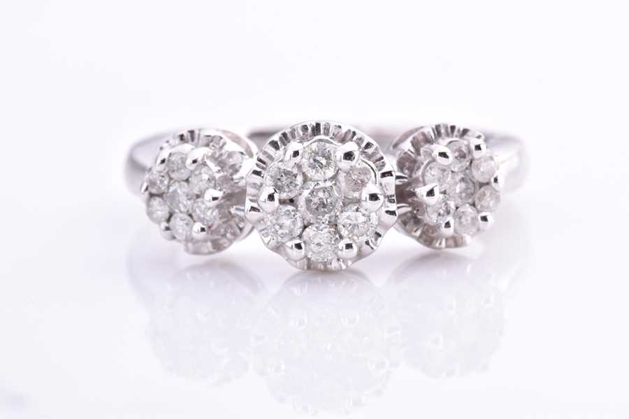 Lot 542 - A white metal and diamond ring set with three...