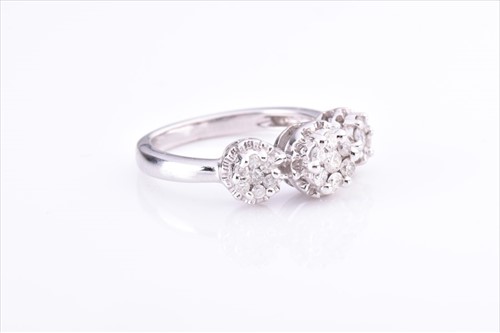 Lot 542 - A white metal and diamond ring set with three...