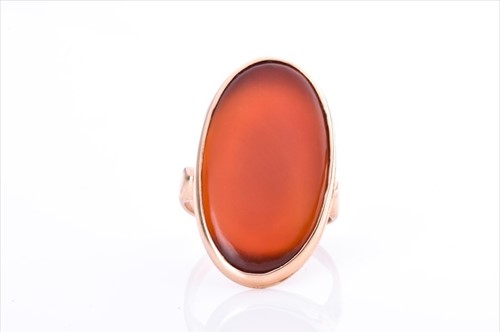 Lot 456 - A yellow metal and carnelian ring set with an...