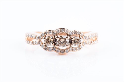 Lot 601 - A white and cognac diamond ring centred with...