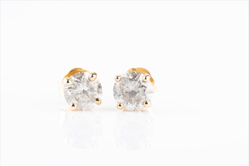 Lot 606 - A pair of round brilliant-cut diamond ear...