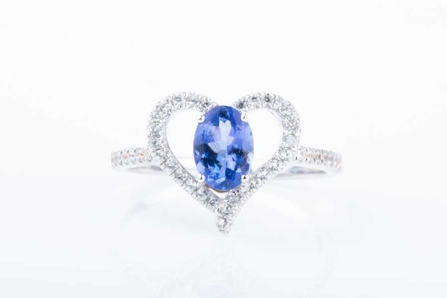 Lot 460 - A white sapphire and tanzanite heart-shaped...