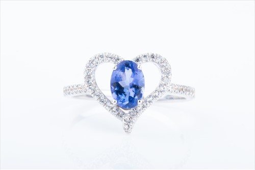 Lot 460 - A white sapphire and tanzanite heart-shaped...