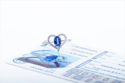 Lot 460 - A white sapphire and tanzanite heart-shaped...