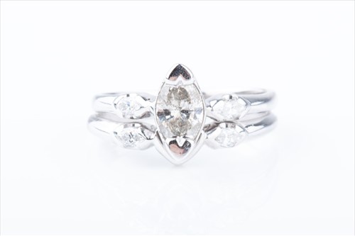 Lot 392 - An unusual diamond double band ring centred...