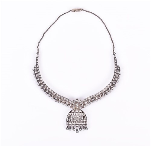 Lot 501 - A white metal and diamond bib-style necklace...