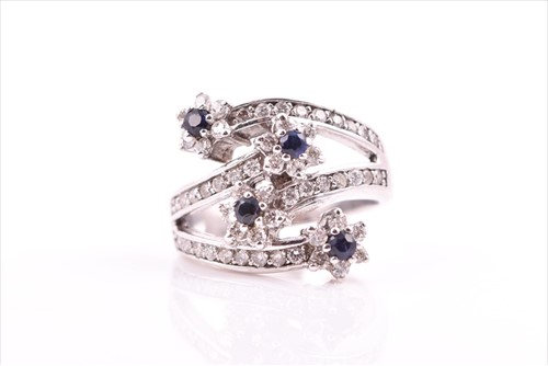 Lot 693 - A diamond and sapphire floral cluster...