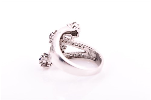Lot 693 - A diamond and sapphire floral cluster...