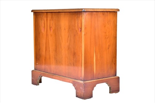 Lot 64 - A small reproduction walnut chestÂ  with two...