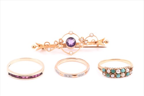 Lot 687 - A 14ct yellow gold and ruby ring channel-set...