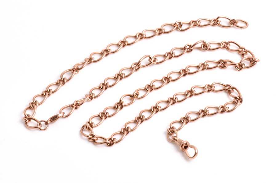 Lot 668 - A 9ct rose gold flattened figaro link chain...