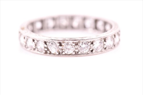 Lot 669 - A platinum and diamond eternity ring set with...